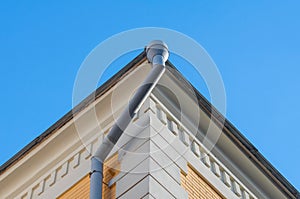 Gray drainpipe on the corner of the building