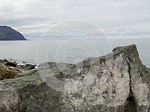 Gray dull landscape with rocks. Black Sea coast in winter. Hopa city, TÃ¼rkiye