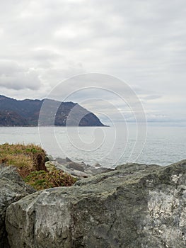 Gray dull landscape with rocks. Black Sea coast in winter. Hopa city, TÃ¼rkiye