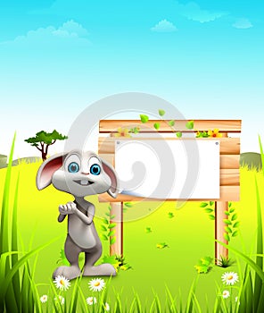 Gray easter bunny in the garden with big wooden sign