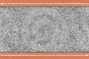 Gray fabric and brown leather background