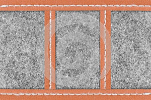 Gray fabric and brown leather background