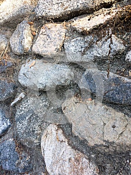 Gray fieldstone wall background pattern of stone