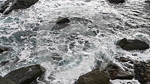 Gray foaming sea and rocks. The terrible Black Sea before the storm.