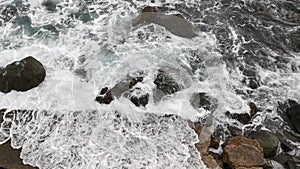 Gray foaming sea and rocks. The terrible Black Sea before the storm.