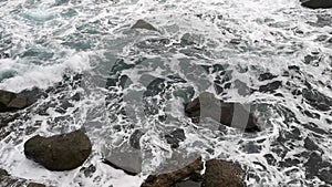 Gray foaming sea and rocks. The terrible Black Sea before the storm.