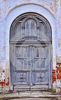 Gray fortress door in the wall, wooden door