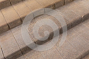 Gray granite brick tiled stairs leading up construction