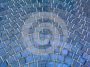 Gray granite cube cobblestone pavement of square shapes. walkway set in radial shape