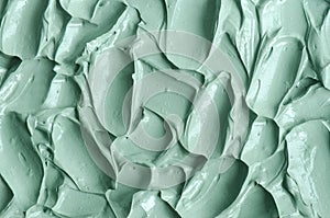 Gray green bentonite facial clay alginate mask, face cream, body wrap texture close up, selective focus. Abstract background