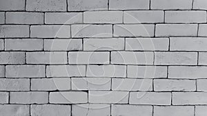 Gray or grey brick wall for background in black and white tone or monochrome.