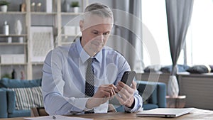 Gray Hair Businessman Using Smartphone