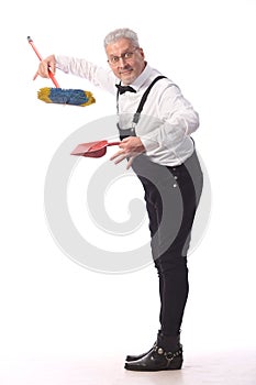 Gray-haired cleaner, janitor in a black jumpsuit with a mop and dustpan provides cleaning service, on white background