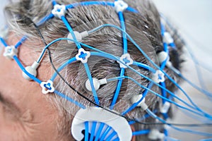 Gray-haired man on the diagnosis of EEG - electroencephalography