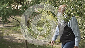 Gray-haired man up the stairs in park