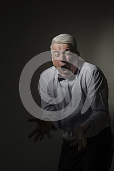 Gray-haired representative man in a white shirt