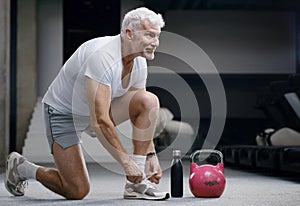 Gray haired senior injured knee or leg. Sport and health care concept