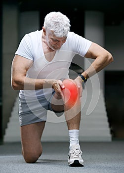 Gray haired senior man looking at sport watch at his hand. Sport and health care concept