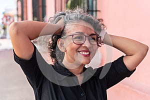 Gray-haired woman laughing outside