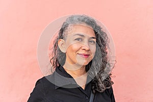 Gray-haired woman posing in the city