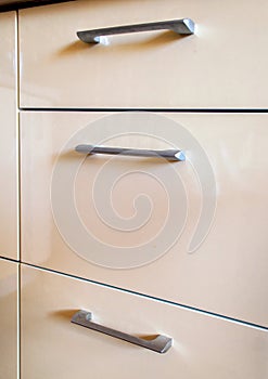Gray handles of the kitchen drawer or cabinet.