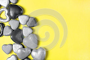 Gray hearts on a yellow background, trending colors of 2021. Copy space, modern Valentine's Day concept