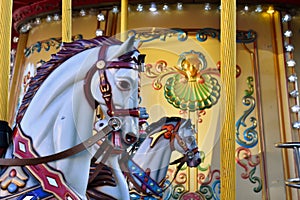 Gray horses on a children`s carousel