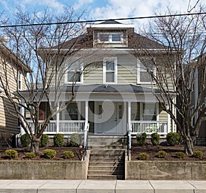 Gray House in Urban Setting with Bare Winter Trees