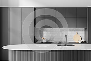 Gray island in white and gray kitchen interior