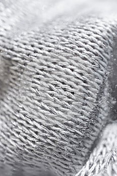 Gray knitted fabric texture closeup.