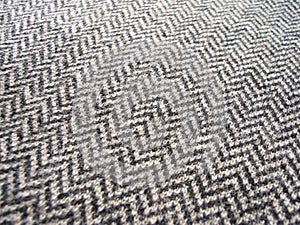 Gray knitted woolen fabric with geometric pattern.