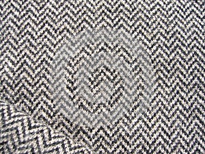 Gray knitted woolen fabric with geometric pattern.