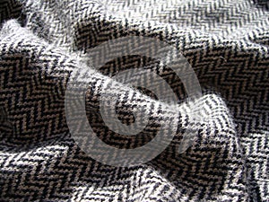 Gray knitted woolen fabric with geometric pattern.