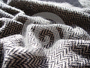 Gray knitted woolen fabric with geometric pattern.
