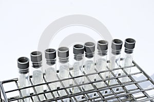 Gray laboratory tube with stainless rack on the white background.