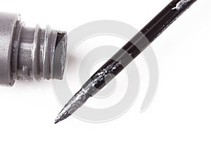 Gray liquid eyeliner brush close-up macro with a tube