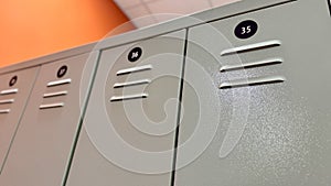 Gray lockers with numbers for people's clothes in the gym locker room