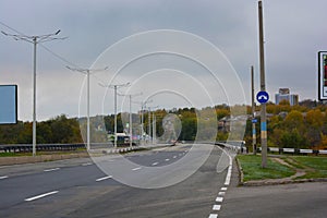 Gray long wide roads, highways of the city of Kamianske. An industrial landscape with an intense life and work.