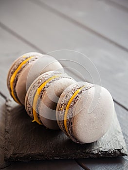 Gray macaroons on dark grey background