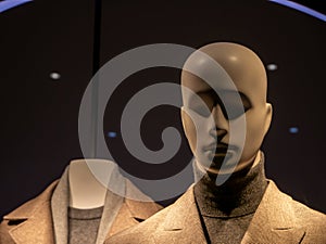 A gray man mannequin with fashion clothes