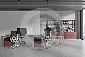 Gray and maroon open space office interior with workspace near blank wall