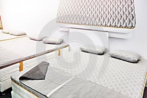 Gray mattress on double bed in store