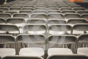 Gray metal chairs in a conference room before the event