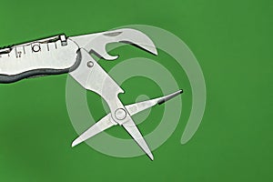 Gray metal scissors and a can opener on a multitool