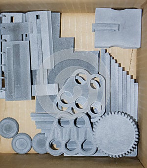 Gray models printed on 3D printer from polyamide powder in a box. Top view.