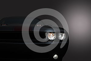 Gray modern car closeup on black background.