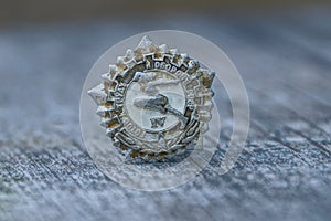 Gray old sporting soviet badge on wooden table