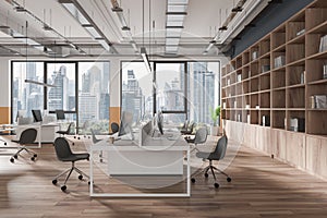 Gray open space office interior with book case