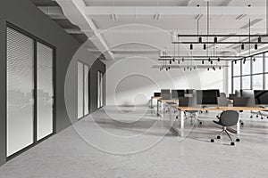 Gray open space office interior with white wall and hot desks