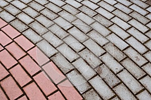 Gray paving stones after rain as background. Road surface in urban environment. Transport infrastructure